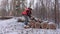 Lumberjack near pile of small logs
