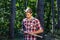 Lumberjack standing with axe on forest background. Deforestation is a major cause of land degradation and