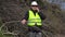 Lumberjack talking on cell phone near pile of branches