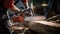 lumberjack using a chainsaw to cut through a large log.