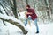 Lumberjack in winter forest. Bearded hipster with axe. Serious lumberjack on winter day outdoors