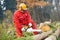 Lumberjack Worker With Chainsaw In The Forest