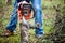 Lumberjack worker in full protective gear cutting firewood