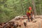 A lumberjack working safely with chainsaw and protection equipment inside an Italian forest