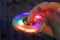 Luminous fidget spinner in hand. Popular trendy toy close-up.