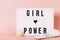 Luminous `girl power` poster with menstrual cup and reusable pad. Feminist themed letters with pink background. Feminism concept