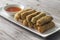 Lumpia Spring Rolls on Wooden Table in Restaurant