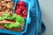 Lunch box with appetizing food on bag, closeup