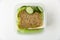 Lunch box with cheese and lettuce sandwich and fresh cucumber. L