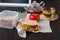 Lunch box with chicken salad sandwiches. Fruits and tea on workplace background