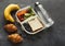 Lunch box with healthy food on black table background