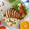 Lunch box: rotini with baked chicken breast and salad. Top view, flat lay. Delicious healthy lunch.