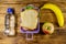 Lunch box with sandwiches, bottle of water, banana and apple on a wooden table. Top view