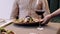 Lunch at cafe. Close up shot of waiter putting plate with salad portion to customer