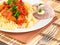 Lunch dish of Italian pasta, vegetable sauce and a slice of meat