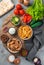 Lunch, French fries, fried meat, vegetables, pita bread and sauces on a gray background.