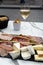 Lunch with glass of brut champagne sparkling wine and meat and cheese platter in street cafe in old central part of city Reims,