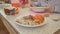 Lunch in the kindergarten. The child eats soup from a plate. Close-up of baby hands.