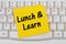 Lunch and Learn, computer keyboard and sticky note