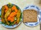 Lunch plate. Portion control. A side of salad two cups. A side of baked chicken strips, A slice of seeded wheat bread.