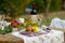 Lunch is romantic in autumn garden, atmosphere of holiday and coziness. Autumnal dinner in the open air with wine and fruit. Decor