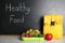 Lunch for schoolchild on table near blackboard