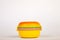 Lunchbox in the form of a yellow hamburger for preserving and carrying homemade food or sandwiches during working day. The symbol