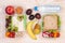 Lunchboxes with sandwiches, fruits, vegetables, and water