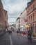 Lund, Sweden - August 4, 2020: A narrow cobblestoned city street in the university town with colorful banners hanged above it