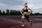 Lunge exercise for quadriceps by athlete on track
