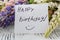 Lupine flowers with message card on a old wooden table