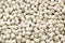 Lupine seeds close up. Background from lupine seeds, top view. Sweet lupine beans, texture. Dry lupine seeds, background