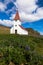 Lupines and white church with red roof church in Vik, Iceland