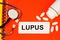 Lupus is an autoimmune disease, the text of the medical diagnosis is written on a form in the doctor`s folder. Medication