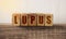 Lupus word written on wooden cubes. Healthcare medical concept