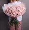 Lush bouquet of pink roses in the hands of the girl, fresh flowers