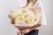 Lush bouquet of rare chrysanthemum. Young girl holding a flowers arrangements with various of colors. white wall.