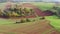 Lush farming landscape with a tractor from above 4k 30fps video