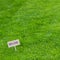 Lush green grass with an Organic sign