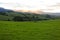 Lush green hills landscape in Australia at sunset