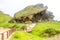 Lush green landscape and Marneef Cave at Al Mughsayl Beach Mountains, Salalah, Oman