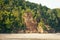 Lush jungle and big cliff near sand beach