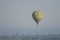 Lush scenery of Murchison Falls National Park with hot air balloon in the background