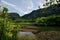 Lush Tropical River and Mountains