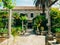 Lush vegetation, paved passageway and pavilion at arboretum in Trsteno