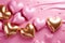 Lustrous golden hearts amid glossy pink ones on fluid background, symbolizing luxury, love, perfect for Valentine's