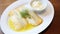 Lutefisk - Traditional Norwegian dish of dried fish rehydrated, on a white plate with melted butter