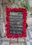 Luther Burbanks about flowers written on a chalk board surrounded by red roses in Prague, Czech Republic