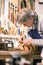 Luthier carefully carving the shape of a lute