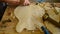 Luthier craftsman sanding a guitar with a little wood planer